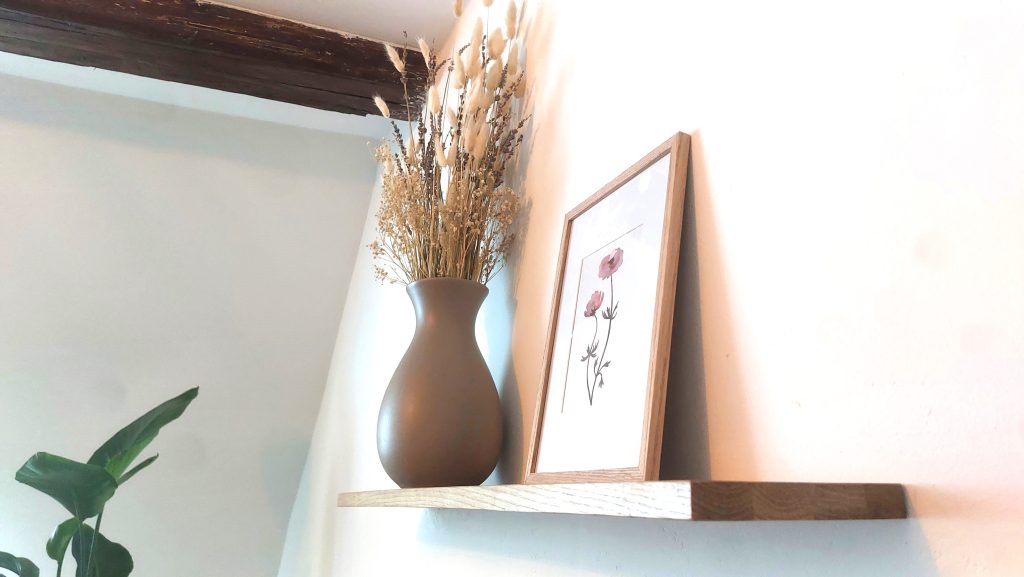 Detail im Wohnzimmer der Kurzeitmiete, mit Vase, Trockenblumen und Gemälde